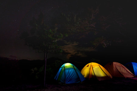 The tents of tourists who go trekking spent overnight on the hilltop in Song Mao Nature Reserve are...