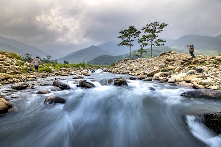 Tu Le, Yen Bai Province, Vietnam - September 18, 2019: Photographer is take photos at a stream in Tu Le, Yen Bai Province, Vietnamのeditorial素材