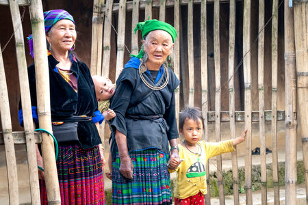 Tu Le, Mu Cang Chai, Vietnam - September 19, 2019: Two ethnic women standing at the front gate of...