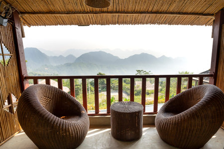 Pu Luong Ecological Garden Resort, Thanh Hoa Province, Vietnam - October 1, 2019: Rattan furniture and tables in the balcony at Pu Luong Eco Garden Resort with great mountain views Beautifulのeditorial素材