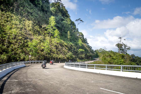 Ho Chi Minh Road, Thua Thien Hue Province, Vietnam - February 8, 2020: Tourists on motorbikes. This section of Ho Chi Minh road passes through the primeval old forest in the national nature reserveのeditorial素材