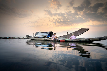 Quang Loi lagoon, Quang Loi commune, Quang Dien, Thua Thien - Hue, Vietnam - May 8, 2020: Images of fishermen working at dawn on Quang Loi lagoon, Thua Thien - Hue, Vietnamのeditorial素材