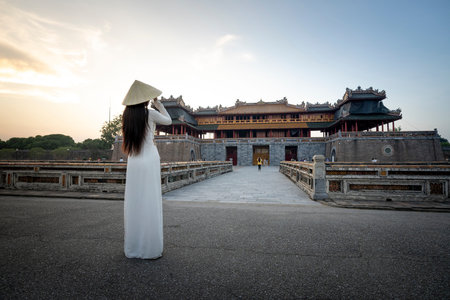 Hue City, Thua Thien Hue Province, Vietnam - May 7, 2020: A scene of a girl in a traditional ao dai costume praying inside a templeのeditorial素材