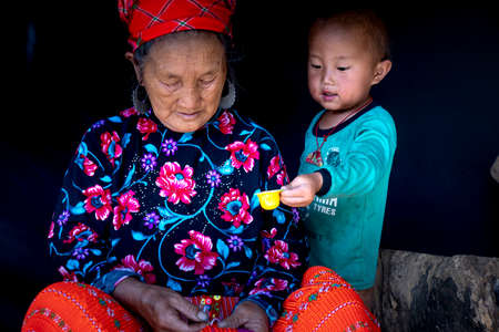 Moc Chau, Son La Province, Vietnam - July 13, 2020: A beautiful portrait of grandma and grandson of ethnic minoritie in Moc Chau district, Son La province, Vietnamのeditorial素材