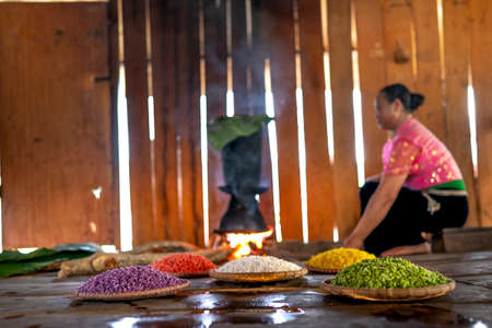 Moc Chau District, Son La Province, Vietnam - July 13, 2020: Two ethnic women cook rice of five colors. Colorful rice. Each type of rice is dyed with a different type of leaf, herb. Thai style in MCのeditorial素材