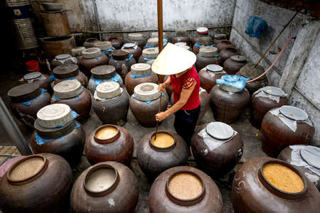 Nghe An Province, Vietnam - July 31, 2020: A woman works at a traditional "soy sauce" food production facility in Nghe An province, Vietnam. Soy sauce is fermented from soybeansのeditorial素材