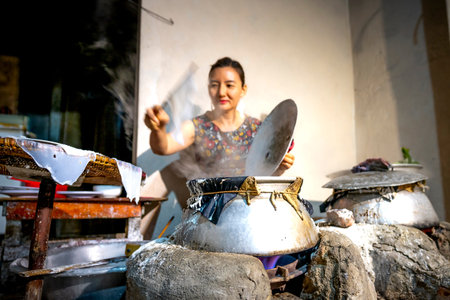 Nghe An Province, Vietnam - August 2, 2020: Vietnamese female make rice paper from rice flour at banh trang trade village, Nghe An Province, Vietnamのeditorial素材