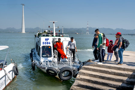 Lan Ha Bay, Quang Ninh province, Vietnam - November 12, 2020: The staff of the 5-star Heritage Cruise company welcomes you to the canoe to transfer to the Heritage Cruise offshoreのeditorial素材