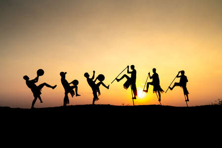 Pleiku Town, Gia Lai Province, Vietnam - March 6, 2021: Ede boys and girls perform their traditional dance during their sunset period in Pleiku town, Gia Lai province, Vietnam. Silhouette.のeditorial素材