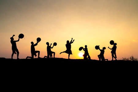 Pleiku Town, Gia Lai Province, Vietnam - March 6, 2021: Ede boys and girls perform their traditional dance during their sunset period in Pleiku town, Gia Lai province, Vietnam. Silhouette.のeditorial素材