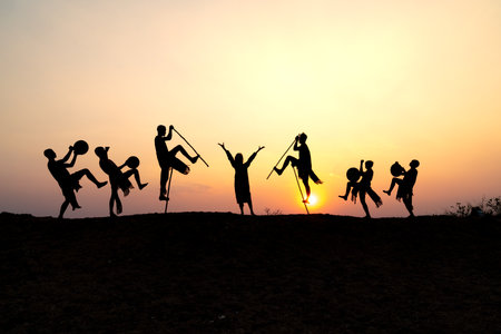 Pleiku Town, Gia Lai Province, Vietnam - March 6, 2021: Ede boys and girls perform their traditional dance during their sunset period in Pleiku town, Gia Lai province, Vietnam. Silhouette.のeditorial素材