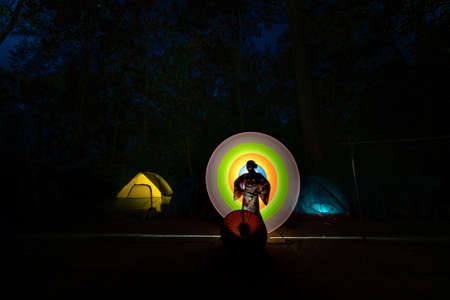 K 'Bang District, Gia Lai Province, Vietnam - March 8, 2021: Tourists photographed light painting next to a camping tent in the jungle in K' Bang district, Gia Lai province, Vietnamのeditorial素材