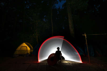 K 'Bang District, Gia Lai Province, Vietnam - March 8, 2021: Tourists photographed light painting next to a camping tent in the jungle in K' Bang district, Gia Lai province, Vietnamのeditorial素材