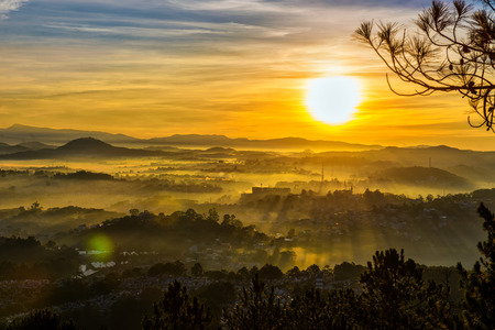 Going to the high mountain to see the morning in Dalat. You will see the ray and the fog, they mix together to make a beautiful sunrise sightseeingの写真素材