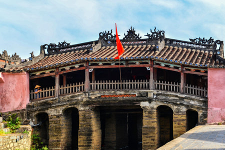 Hoi An, Vietnam - September 02, 2013 - The woman is standing at the Japanese covered bridgeのeditorial素材