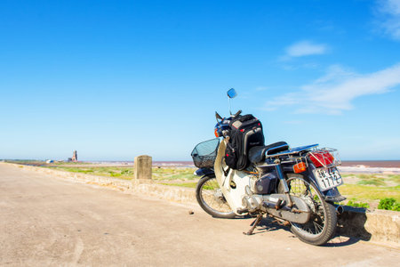 Hai Ly, Hai Hau, Vietnam - June 27, 2015: The motorbike is parked in the street near Hai Ly ruined churchのeditorial素材