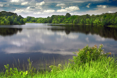 a silent lake with clouds reflectionの写真素材