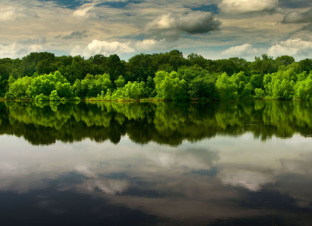 reflection of clouds on a calm lakeの写真素材