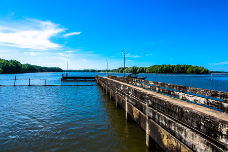 A small dock or gangplank over the sea on mangrove forest and blue sky background.の写真素材