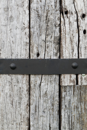 Chock wood with steel plate and black rivet connect background texture.の写真素材