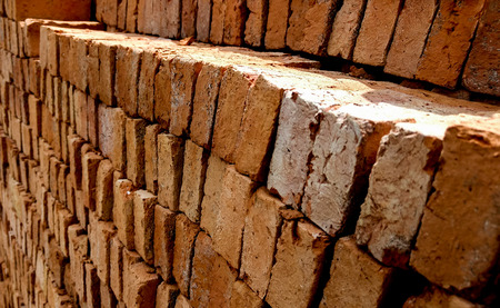 Stack of broken orange old brick, selective focus.の写真素材