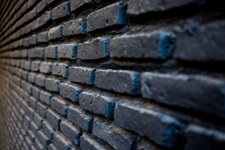 Brick in black colour work wall pattern in one point perspective view, craftmanship in construction building, selective focus.の写真素材