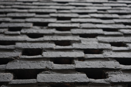 Brick in black colour work wall pattern in one point perspective view, craftmanship in construction building, selective focus.の写真素材