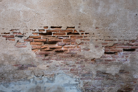 Cracked and decayed brick stucco wall texture background weathered long time ago.の写真素材