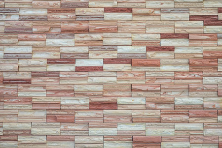 Natural craft stone tile wall made to random pattern background.の写真素材