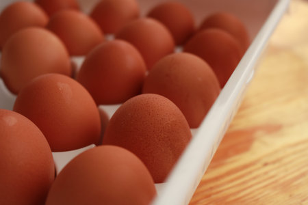 Raw Chicken eggs Full basket in a woody table