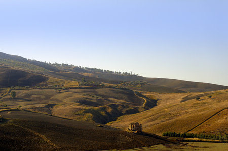 The Countryside of Central Sicily Italy.The land of Sicily has been affected by countless invaders, Greek, Roman, Arab, Norman and Italian. The land is mainly farming land on the vast rolling plains of Central Sicilyの写真素材