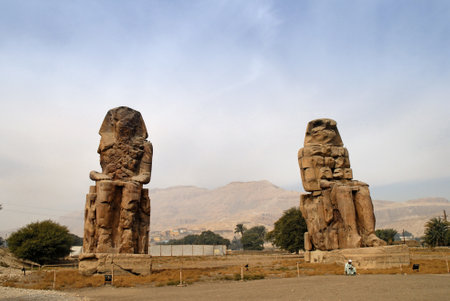 The Colossi of Memnon are two massive stone statues of Pharaoh Amenhotep III. For the past 3400 years they have stood in the Theban necropolis, across the River Nile from the modern city of Luxorのeditorial素材