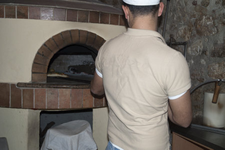 Throwing a Pizza in to wood ovenのeditorial素材