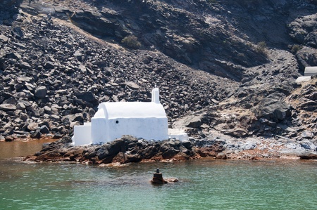 Swimming to Hot Springs in the sea at the volcano in the Caldera of Santorini Greeceの写真素材