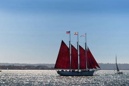 Cannons firing in mock sea battle with Tall Sailing Ships in Harbour of San Diego California USAの写真素材