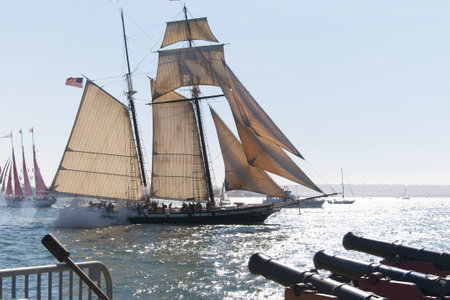 Cannons firing in mock sea battle with Tall Sailing Ships in Harbour of San Diego California USAのeditorial素材