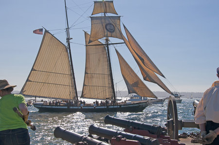 Cannons firing in mock sea battle with Tall Sailing Ships in Harbour of San Diego California USA