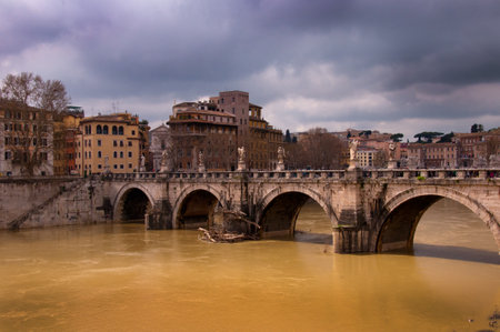 Unusually high River Tiber in Rome Italy with debris piled against the bridgesのeditorial素材