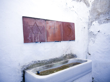 washing trough with Symbols showing Christian,Jewish and Islam followers are welcome to use the water in Frigiliana Spainのeditorial素材