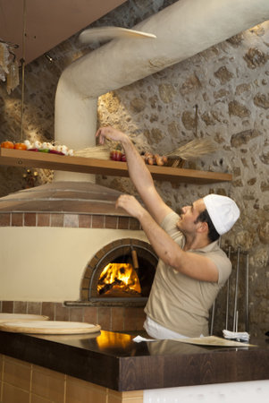Tossing a pizza in Rethymno Pizzeria in Creteのeditorial素材