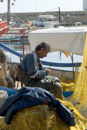 Fisherman in the Harbour at Rethymno in Crete Greeceのeditorial素材
