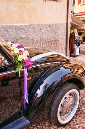 Malcesine is one of the lovely towns on this lake in Northern Italy  It has its own castle guarding the town popular now for weddings  The narrow streets mean wedding cars must be small, so this VW is perfectのeditorial素材