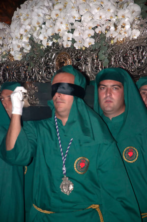 Blindfolded freed prisoner in Maundy Thursday Easter Processions in Nerja Spain
