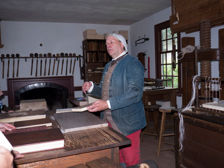 A bookbinder in Historic Colonial Williamsburg where the earliest European settlers established their first colony in Virginia USAのeditorial素材