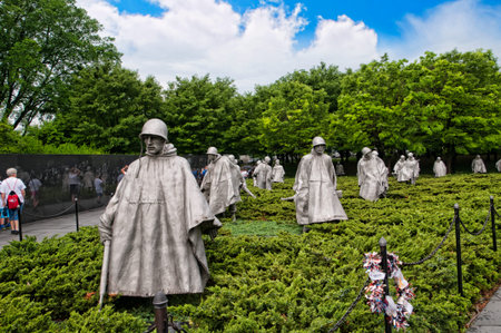 The Korean wall memorial depict 19 statues that depict soldiers on patrol. A granite wall has a mural of the faces of 2,400 unnamed soldiers with a reading that states Freedom is not free.のeditorial素材