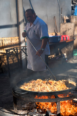 Serving a huge pan of Paella on the Burriana Beach in Nerja Andalucia Spainのeditorial素材
