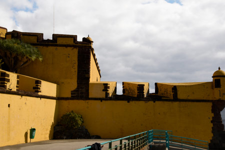 The ancient yellow Fortress of Sao Tiago with its bathing platforms into the Atlantic Oceanのeditorial素材