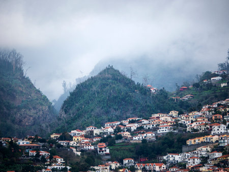 Mists roll down the mountains of Madeira sometimes enveloping the city of Funchalのeditorial素材
