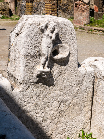 Street water tap in Herculaneum, or Ercolana, near Naples in Italy was not buried by falling rocks like Pompeii was in the eruption of Vesuvius in 79AD, instead it was engulfed in boiling mud and superheated air. This preserved roofs, buildings and artefaのeditorial素材