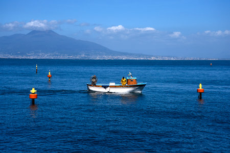 Fishing off the original fishing harbour of Marina Grande in Sorrento a small city in Campania, Italy.  It is a busy fishing port supplying the town and a popular European tourist destination. Vesuvius is in the distanceのeditorial素材